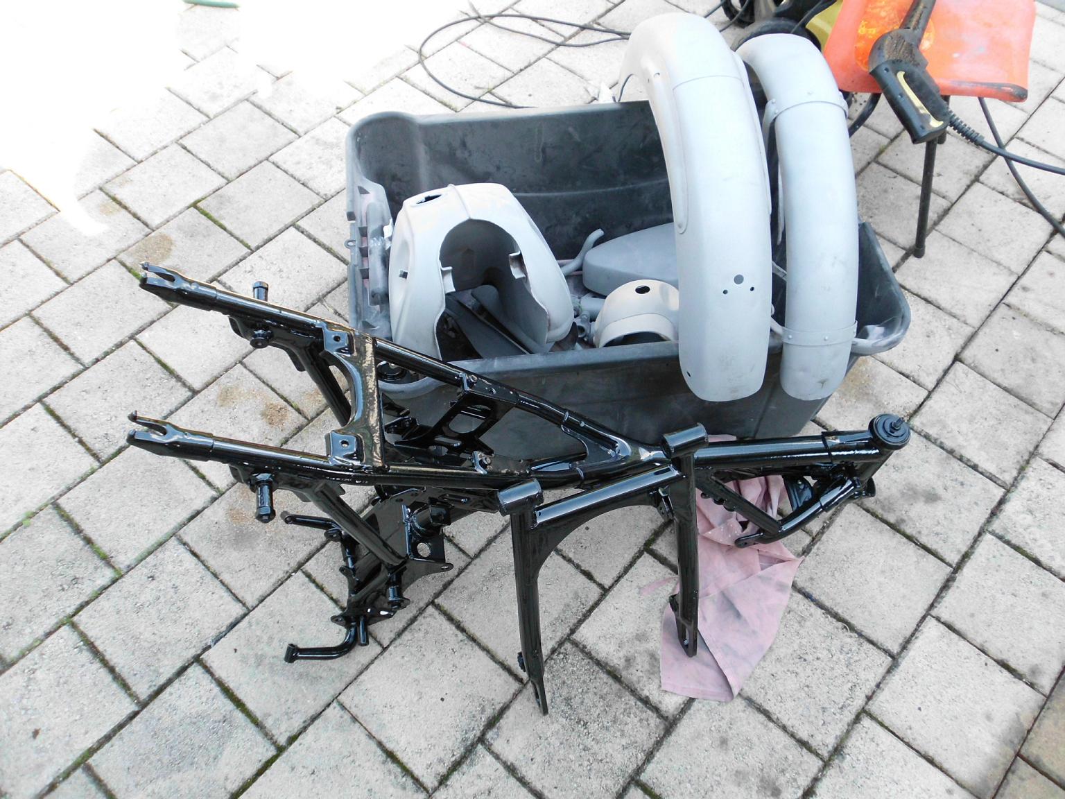 After much deliberation I decided on powder coating of the frame and swing arm. The heavy build is not quite period looking but smart non the less. I managed to get the frame swing arm and addtional components blasted for a very competitive price. Note th